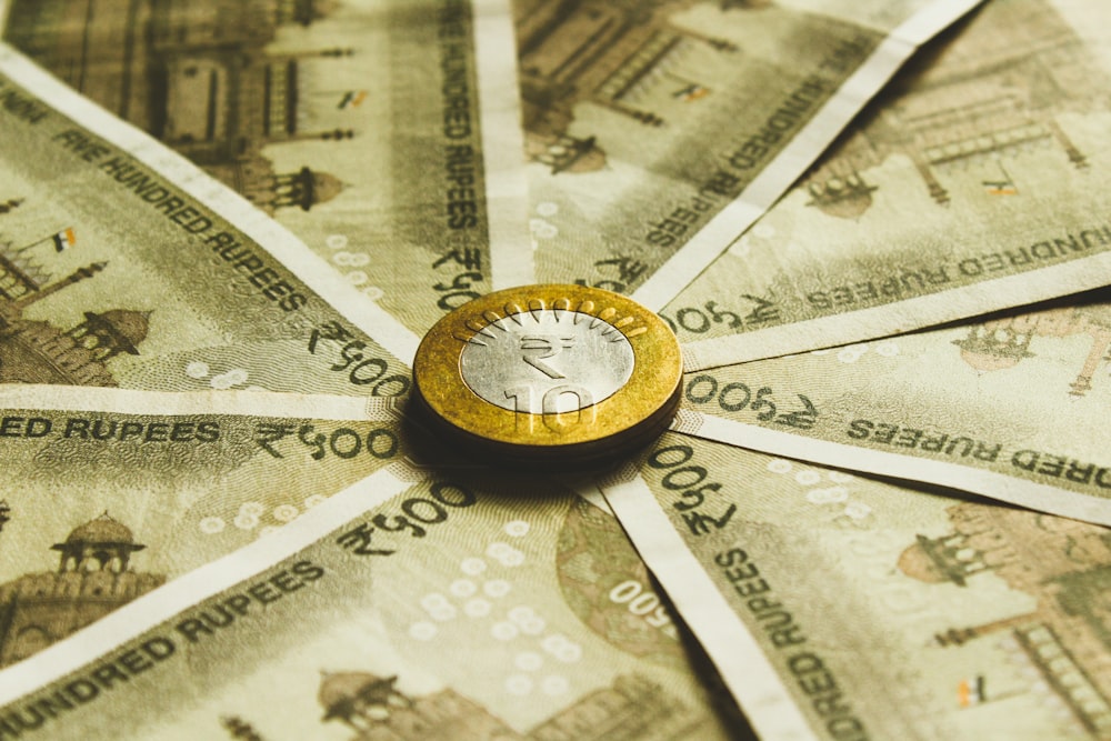 Indian rupee coin and banknotes, representing the firm's tax and accounting practice